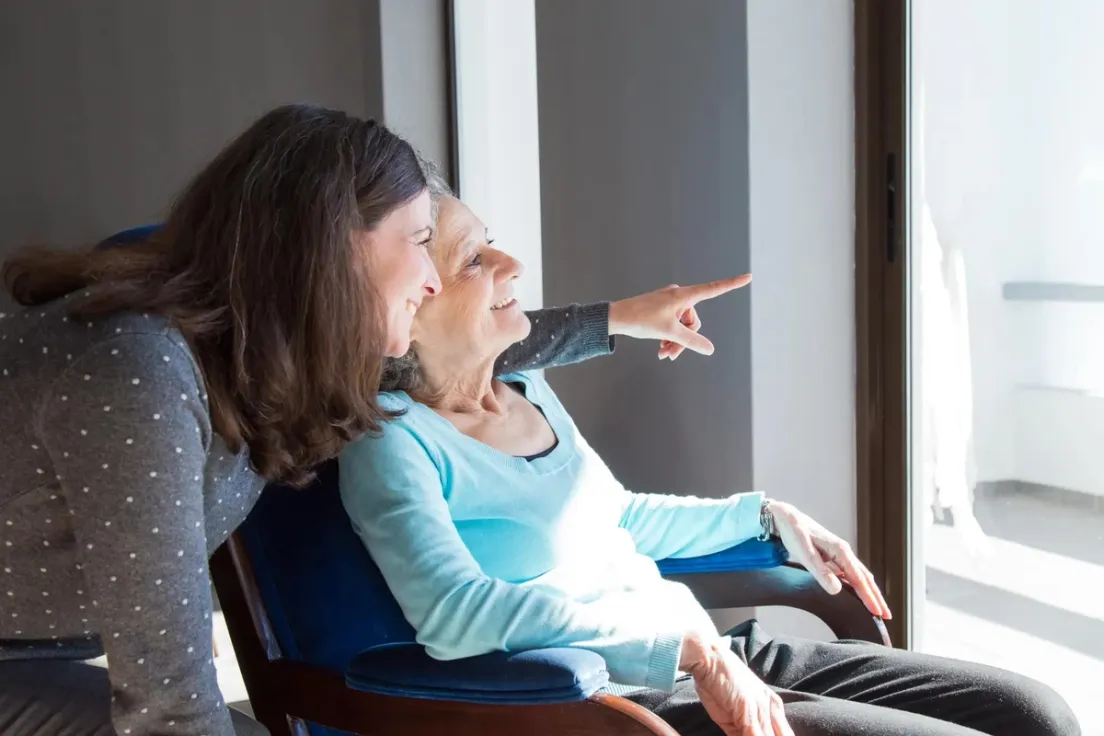 Woman assisting elderly parent at home under Canada Caregiver Program