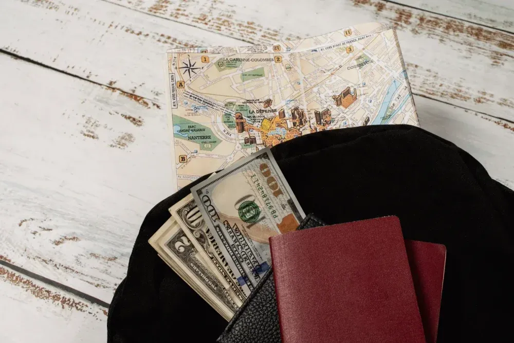 Passport and cash with travel map symbolizing fraud in immigration services charging fees without providing services