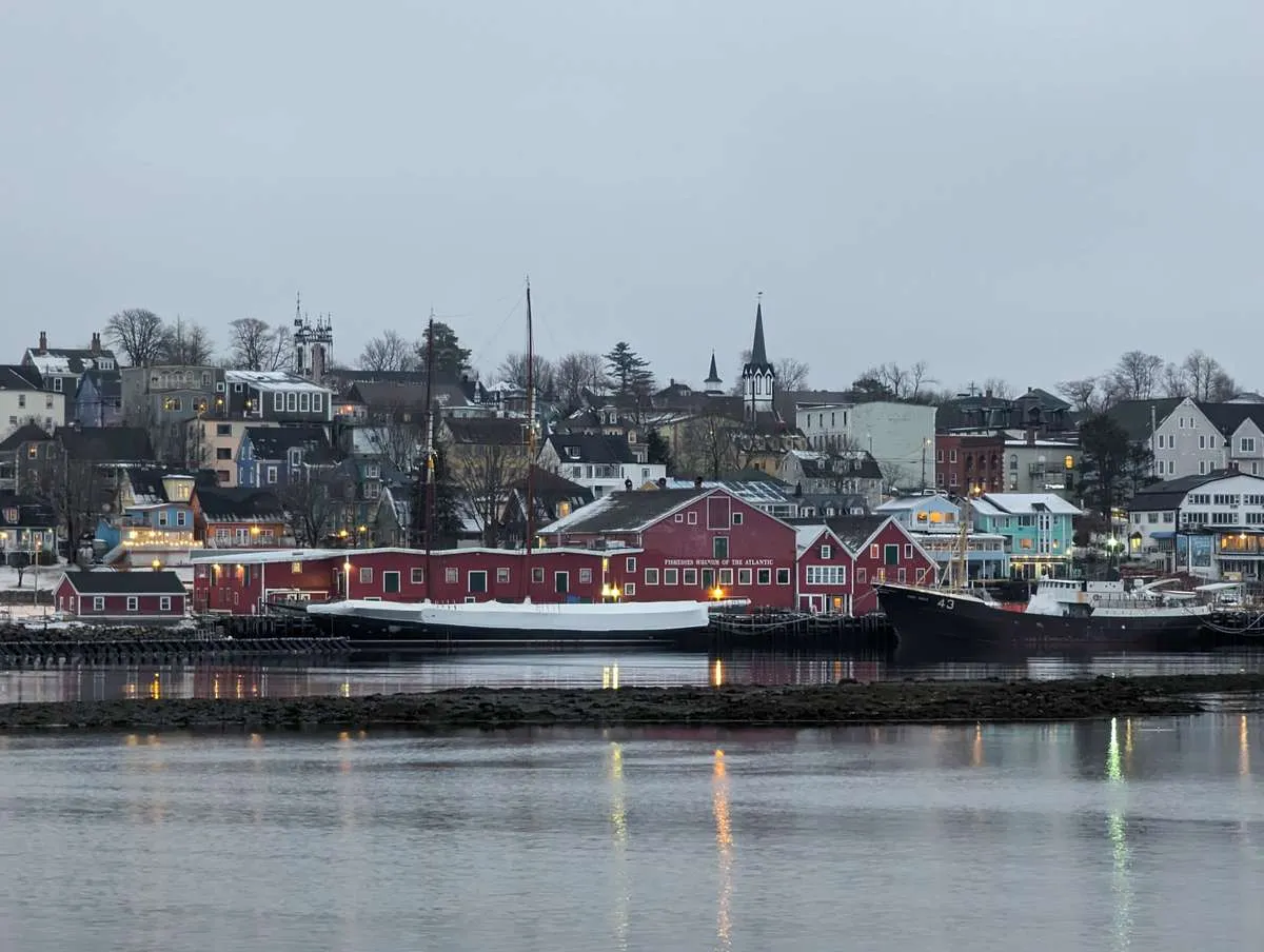 Historic red buildings and boats along the waterfront harbor of Lunenburg, Nova Scotia.