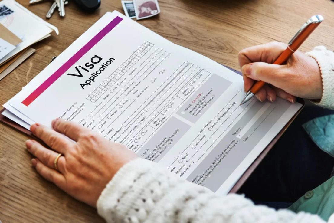 Person filling out a visa application form – understanding GCMS notes for Canada immigration