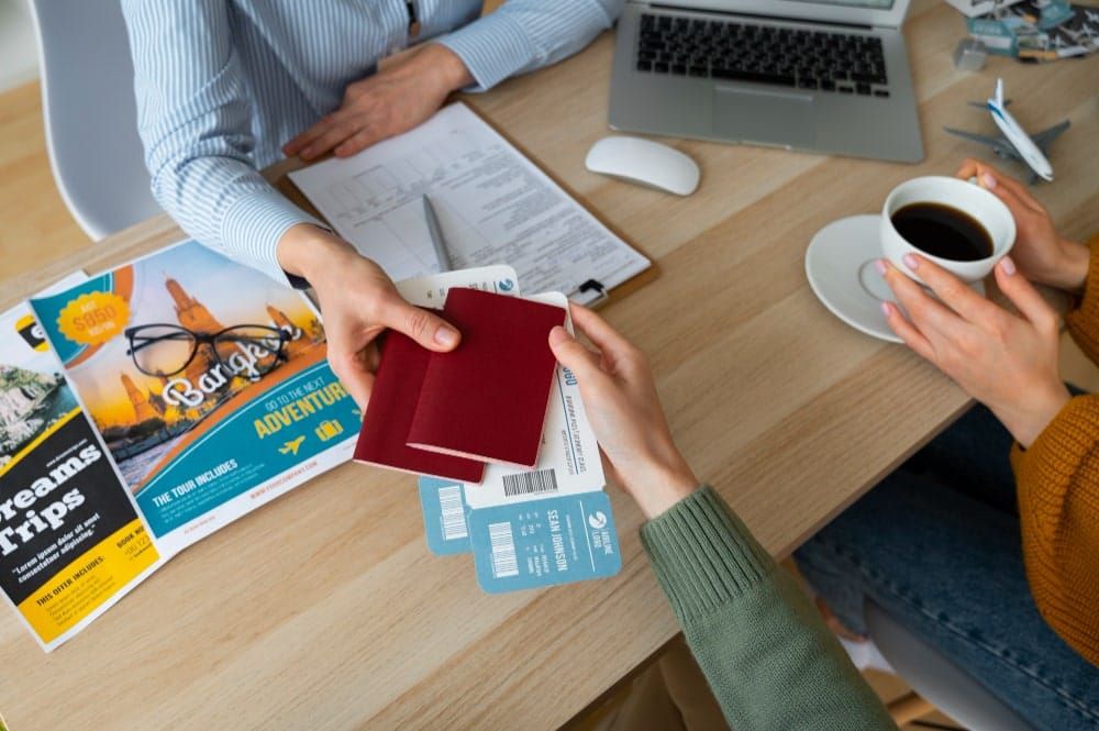 Handing over passports and boarding passes at a travel agency desk
