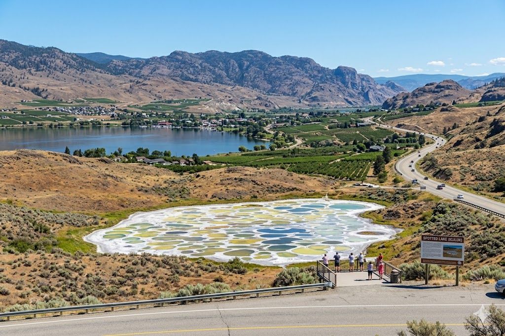 Spotted Lake in Osoyoos, BC, featuring colorful, circular mineral pools surrounded by dry hills.