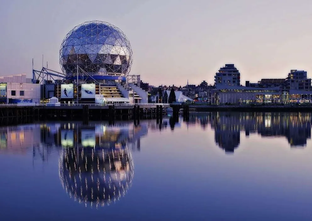 Science World in Vancouver, British Columbia, reflected in False Creek at dusk.