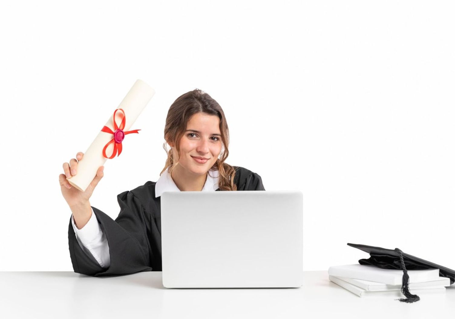 Female graduate holding diploma and using laptop, related to changing universities between provinces in Canada