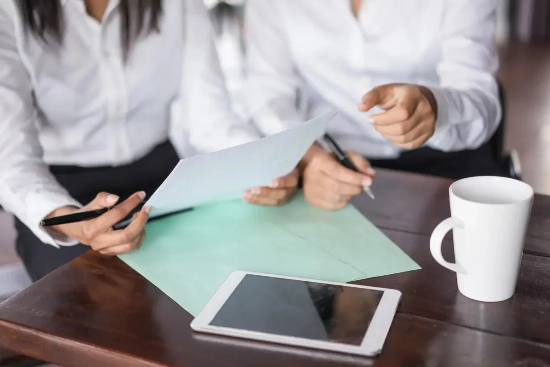Reviewing a Procedural Fairness Letter (PFL) for Canadian immigration application at a desk with documents and tablet