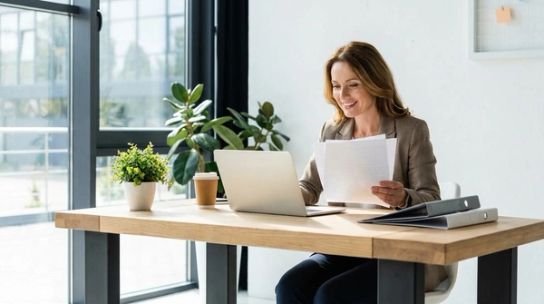Professional immigration consultant reviewing Express Entry documents at a modern desk