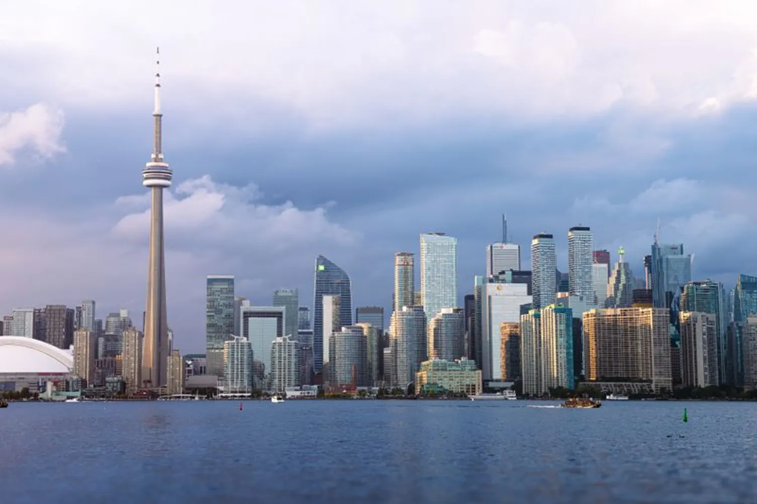Toronto skyline featuring the CN Tower and downtown skyscrapers across the water.