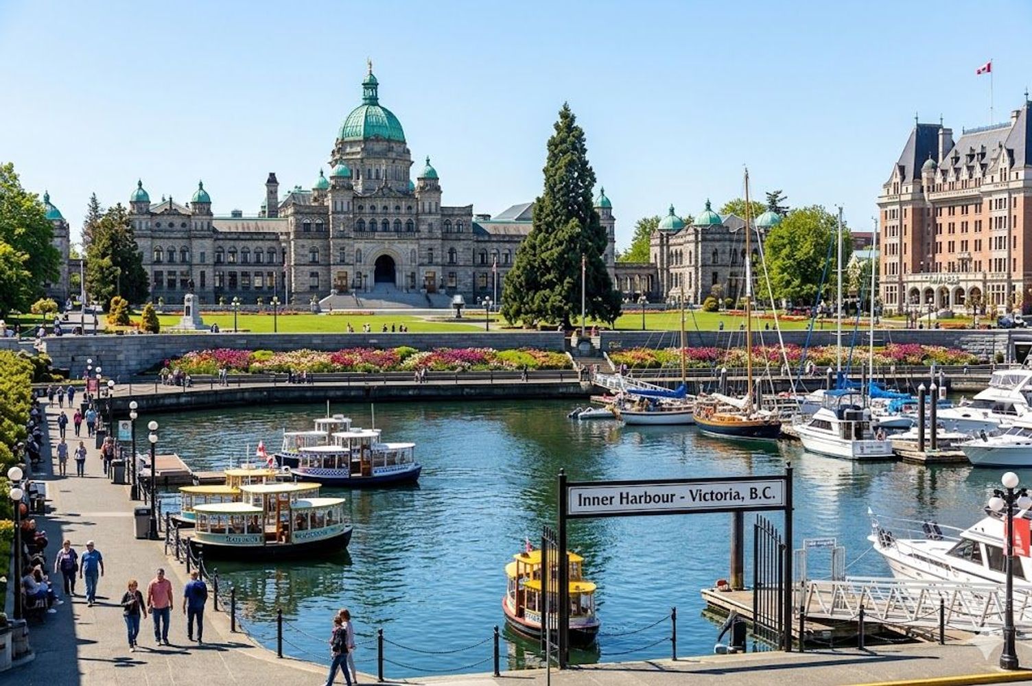 Sunny view of boats in Victoria's Inner Harbour with the Parliament Buildings in the background.
