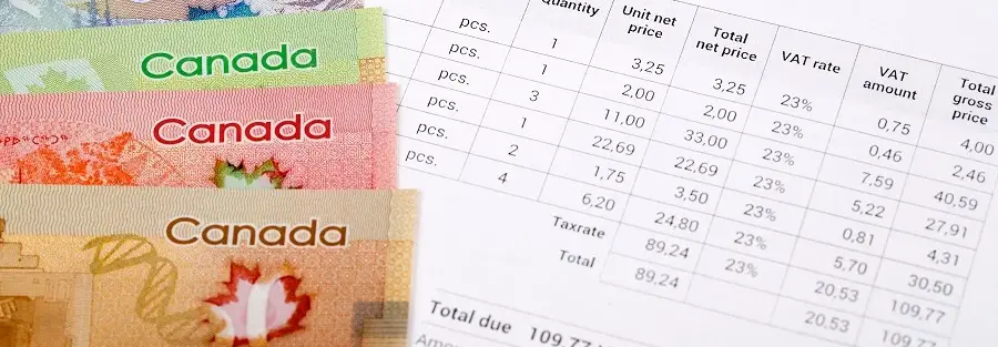 five Canadian dollar bills on a VAT invoice