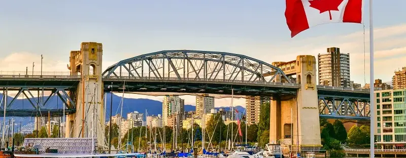 an over-sea bridge with the Canadian flag on the right