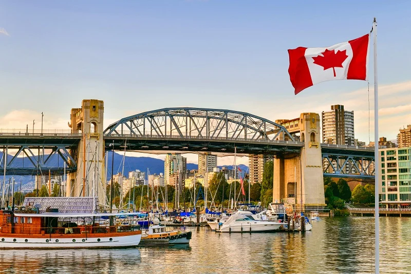 an over-sea bridge with the Canadian flag on the right