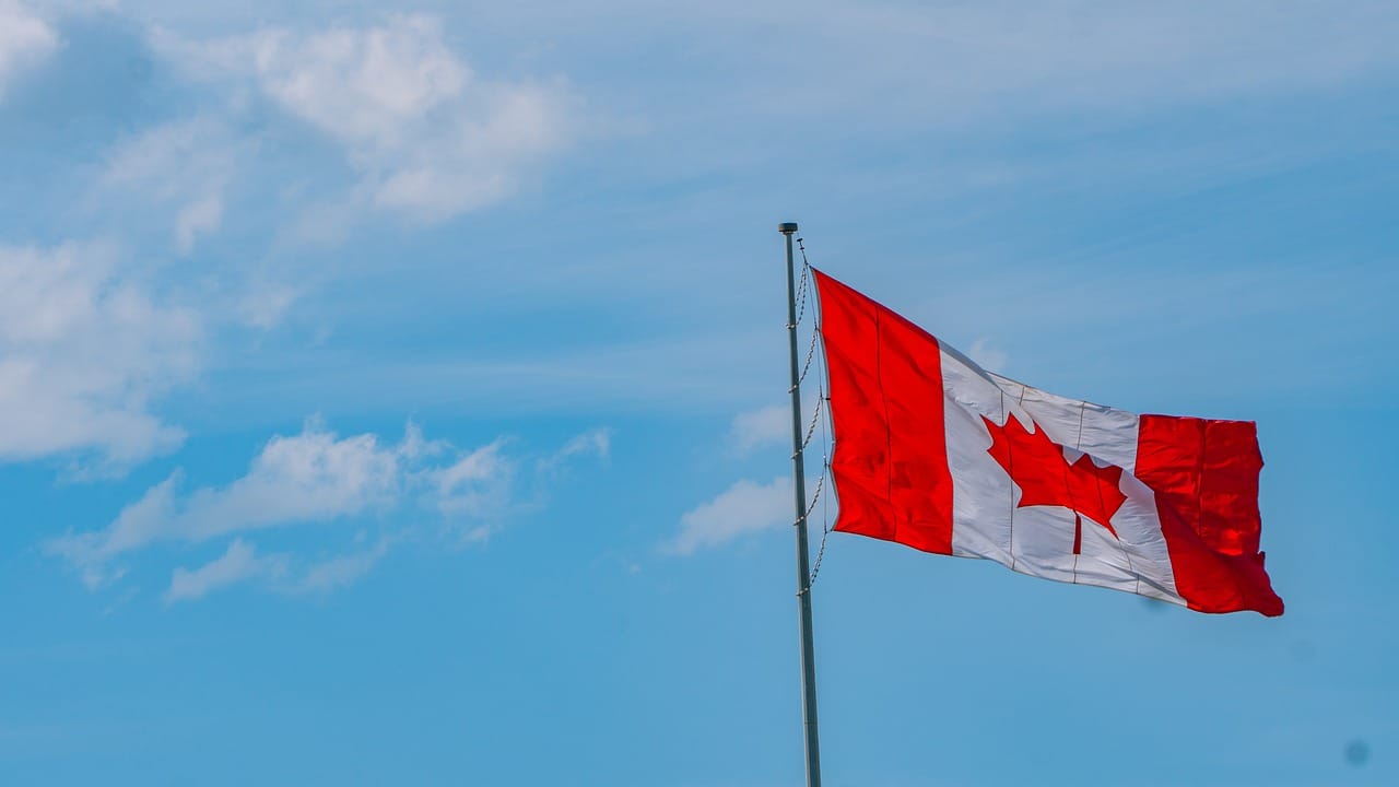 Canadian flag waving in the sky