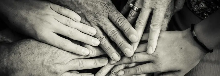 Seven hands held on top of each other