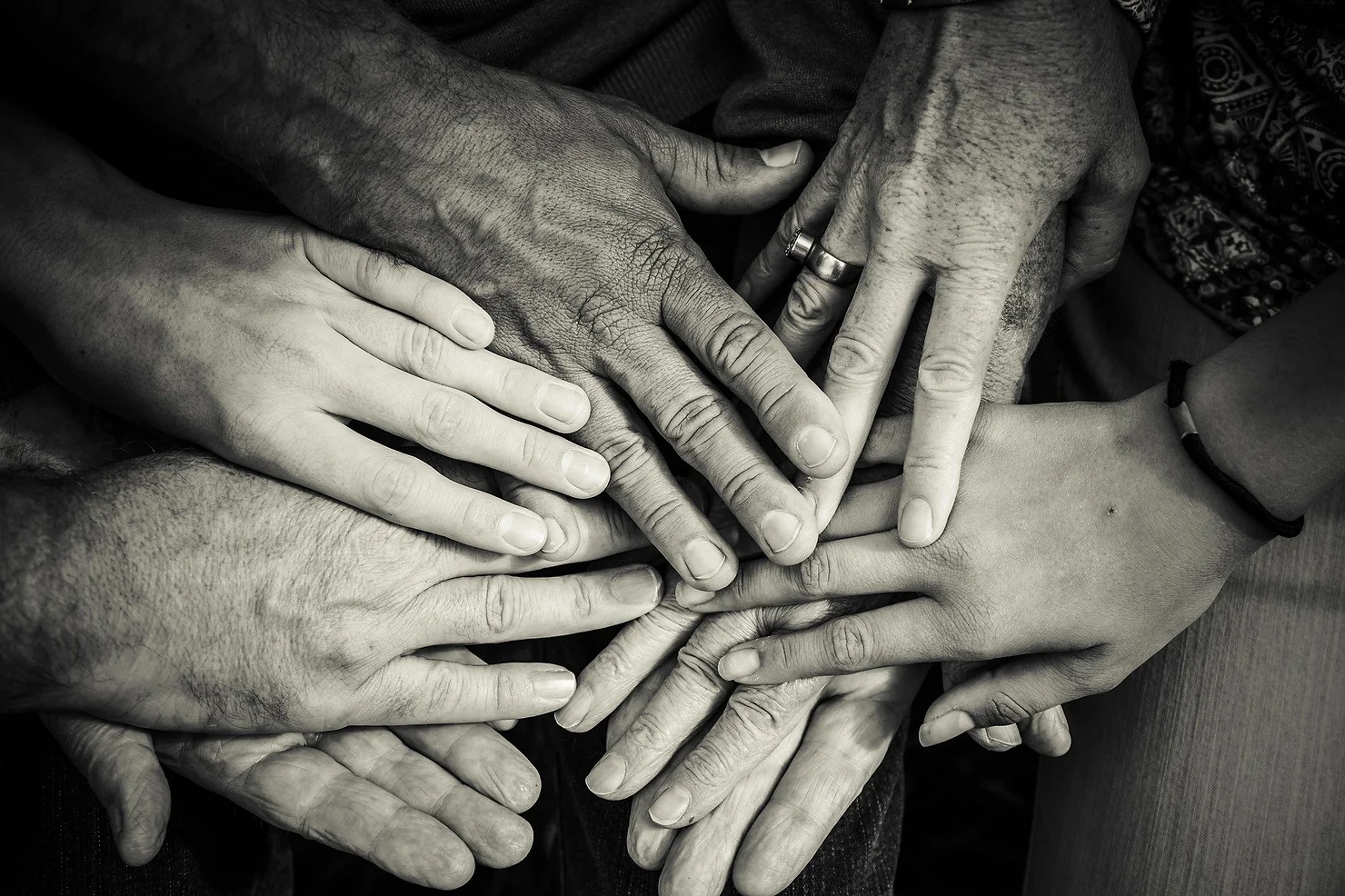 Seven hands held on top of each other