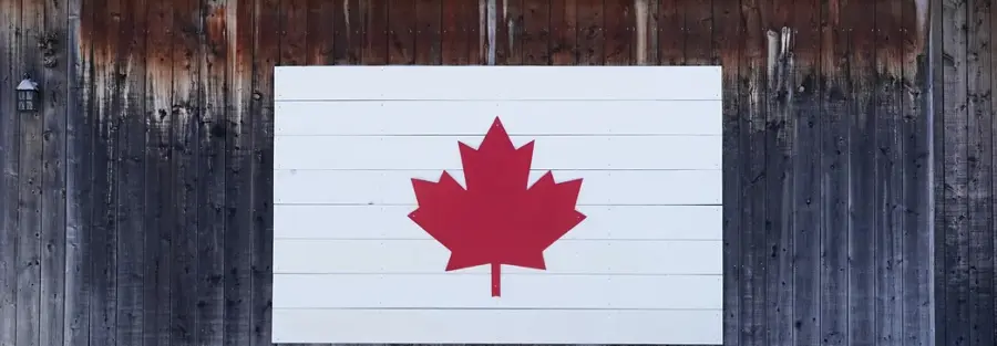 the Canadian symbol on a piece of wood on a cabin