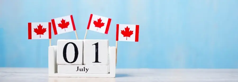 a calendar that shows the 1st of July and four Canadian flags on top