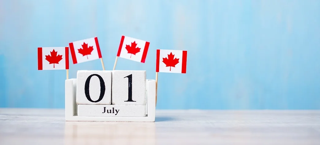 a calendar that shows the 1st of July and four Canadian flags on top