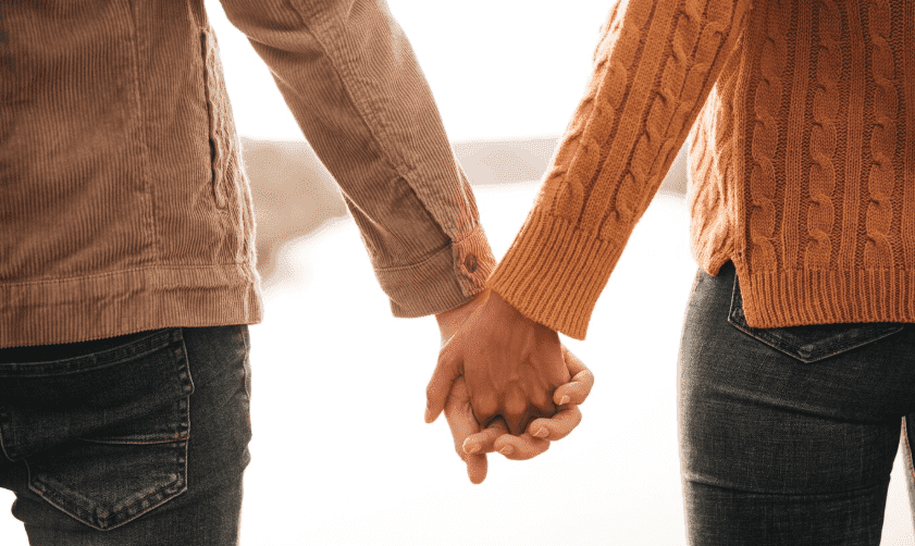 A couple holding hands.