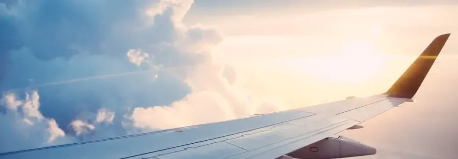 a view of the sky from inside an airplane with the right wing of the airplane being seen