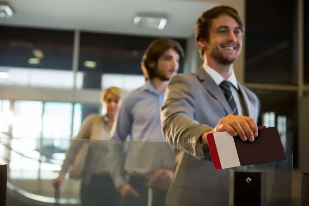Business travelers showing passports at airport security checkpoint.
