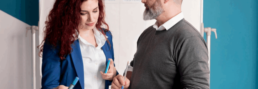 Immigration consultant discussing spousal sponsorship documents with a client in a professional setting.
