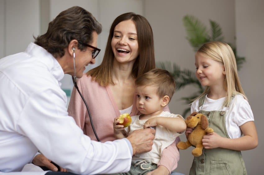 mother with children visiting family doctor in canada