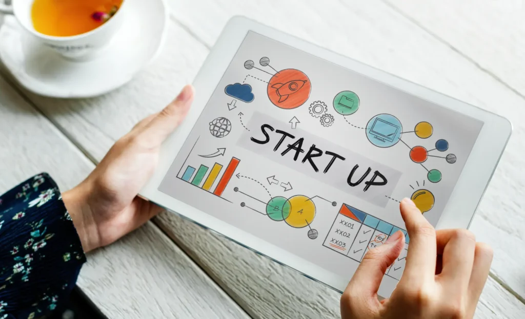 Person using tablet with startup business concept illustration for Canada Startup Visa application