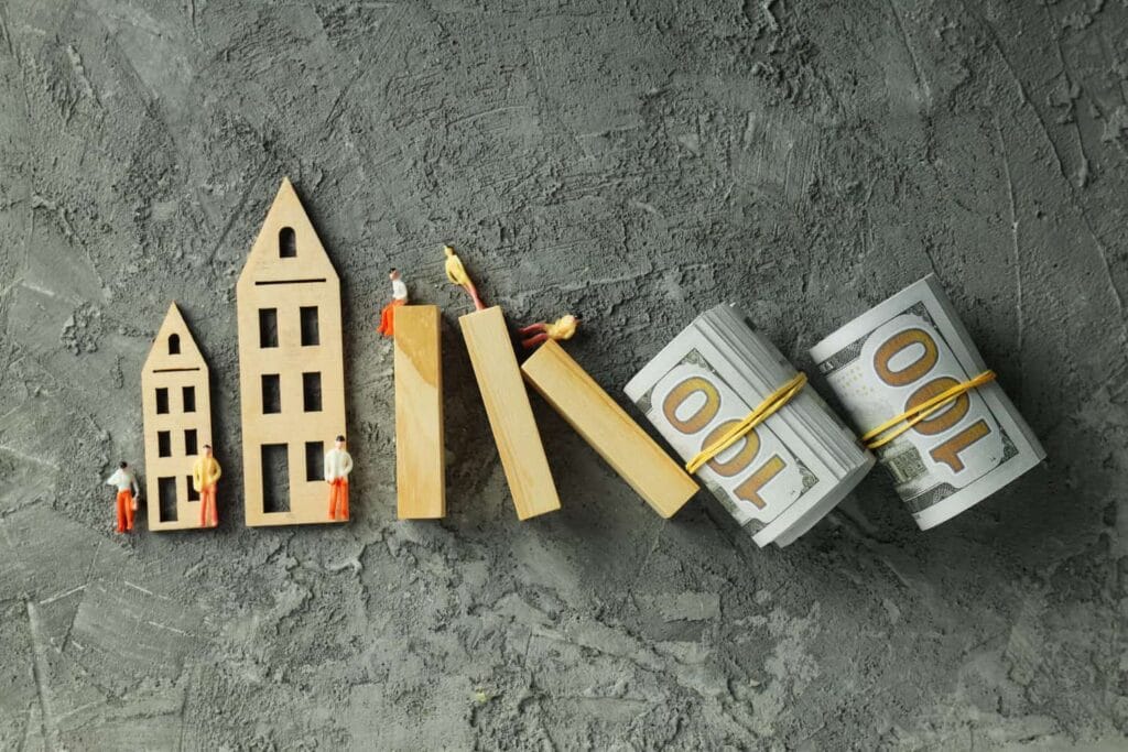 A picture of several houses and money next to each other.