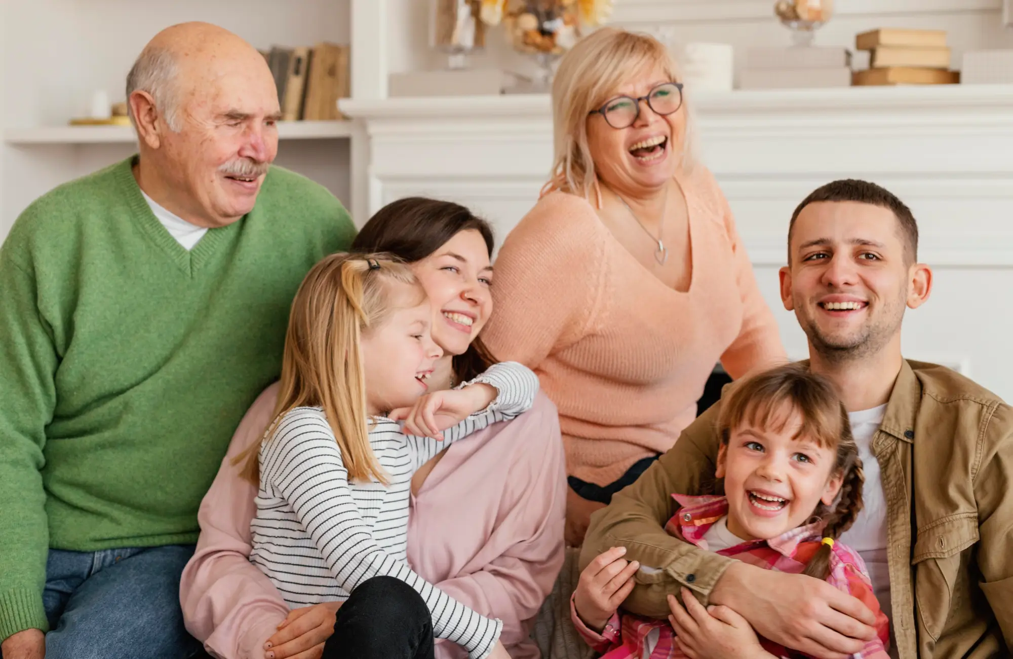 A joyful multi-generational family together, representing the idea of family reunification, a key aspect of Canada's Parents and Grandparents Program.