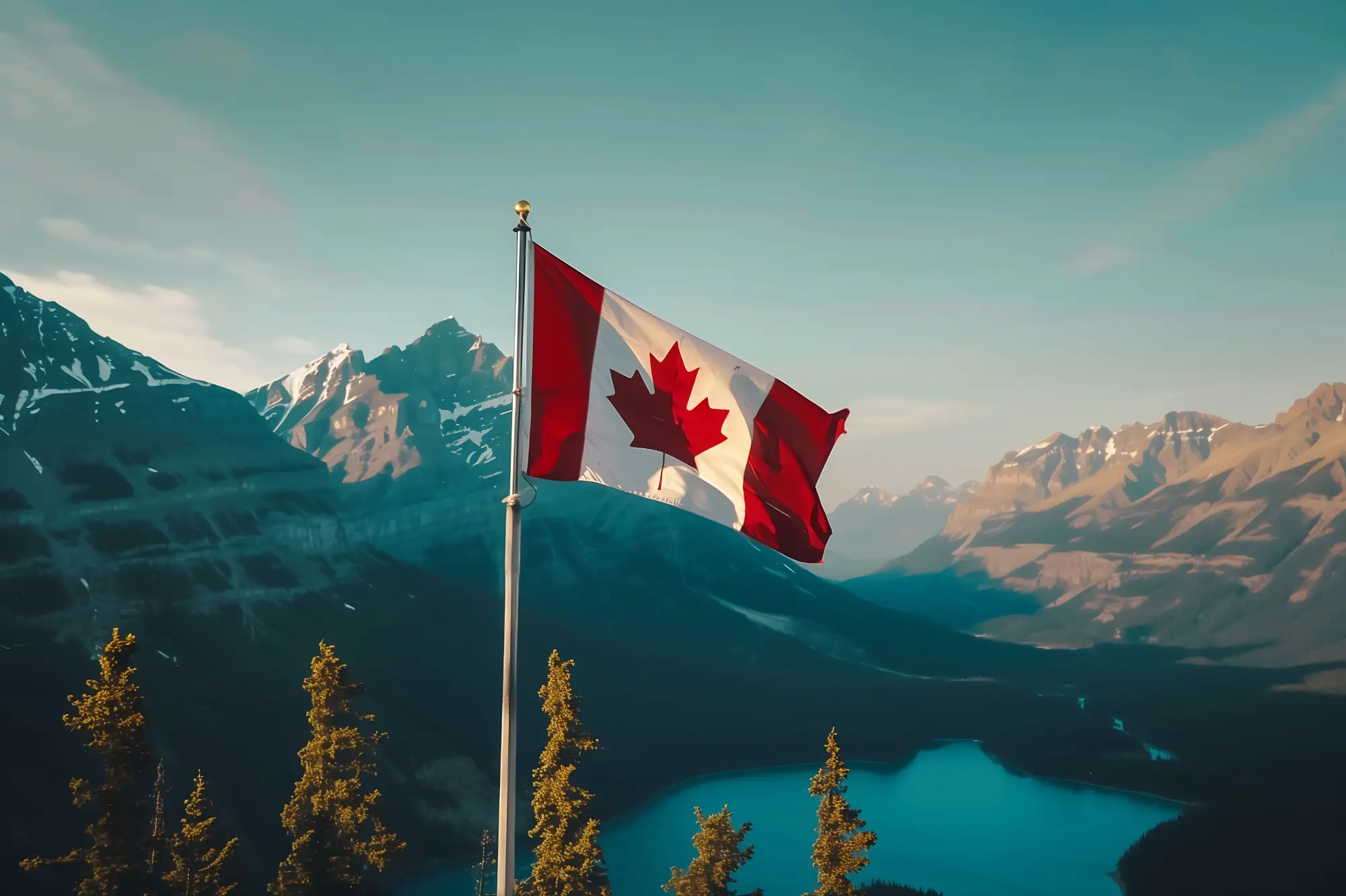 Canadian flag waving over mountain landscape symbolizing expanded work permits for family members of temporary foreign workers