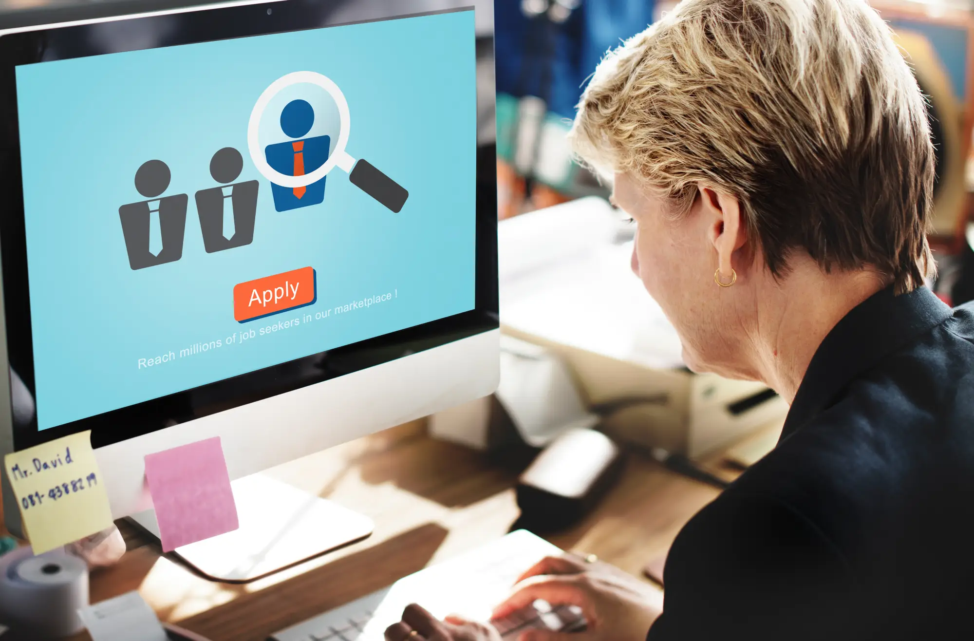 Woman using a computer to apply for a job online, representing the concept of Canada’s High Potential Tech Visa for skilled tech workers without a job offer requirement.