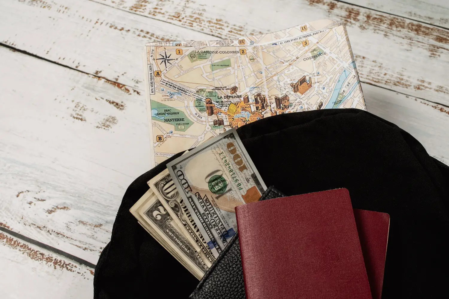 Passport and cash with travel map symbolizing fraud in immigration services charging fees without providing services

