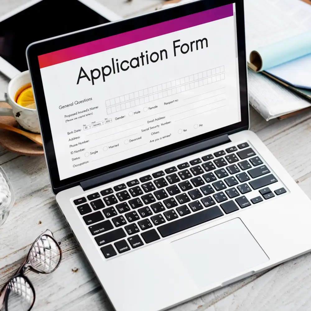 Laptop screen showing an online immigration application form ready for submission